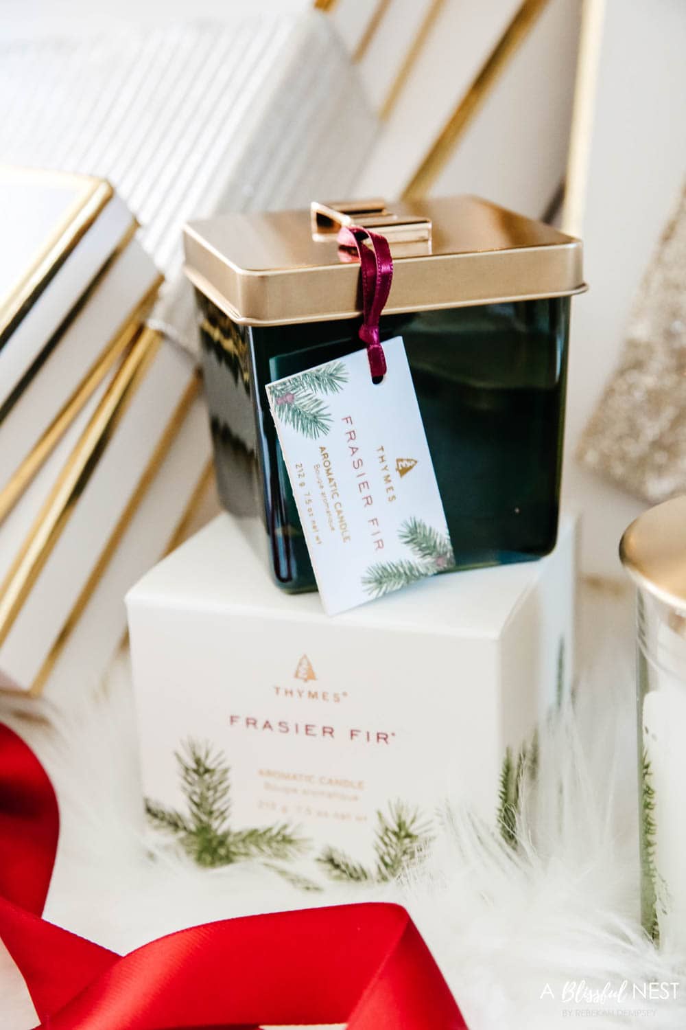 Candles and diffusers from Thymes under a Christmas tree.