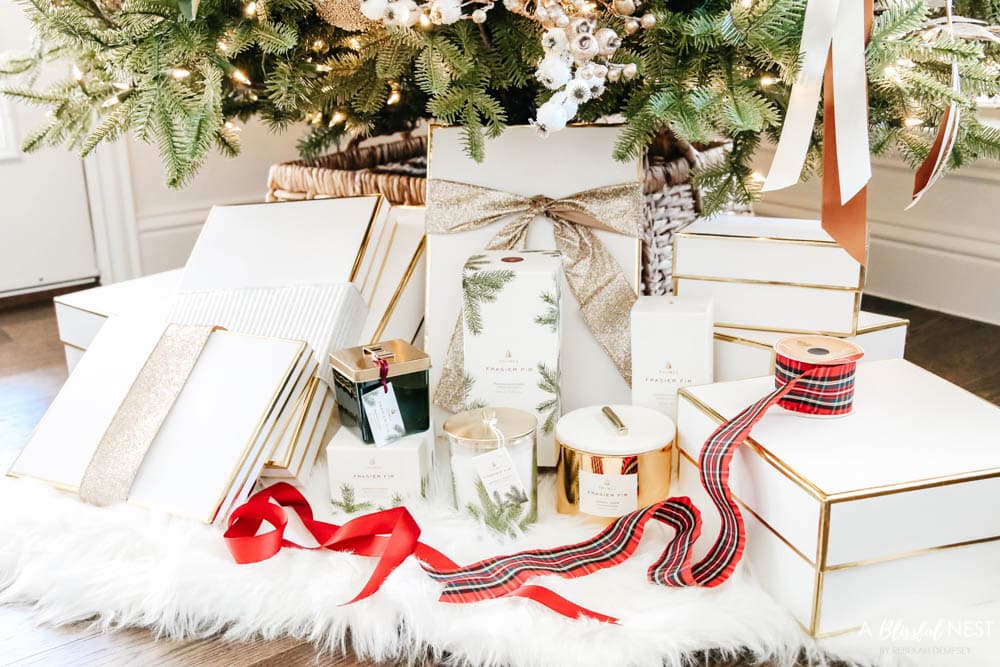 Candles and diffusers from Thymes under a Christmas tree.