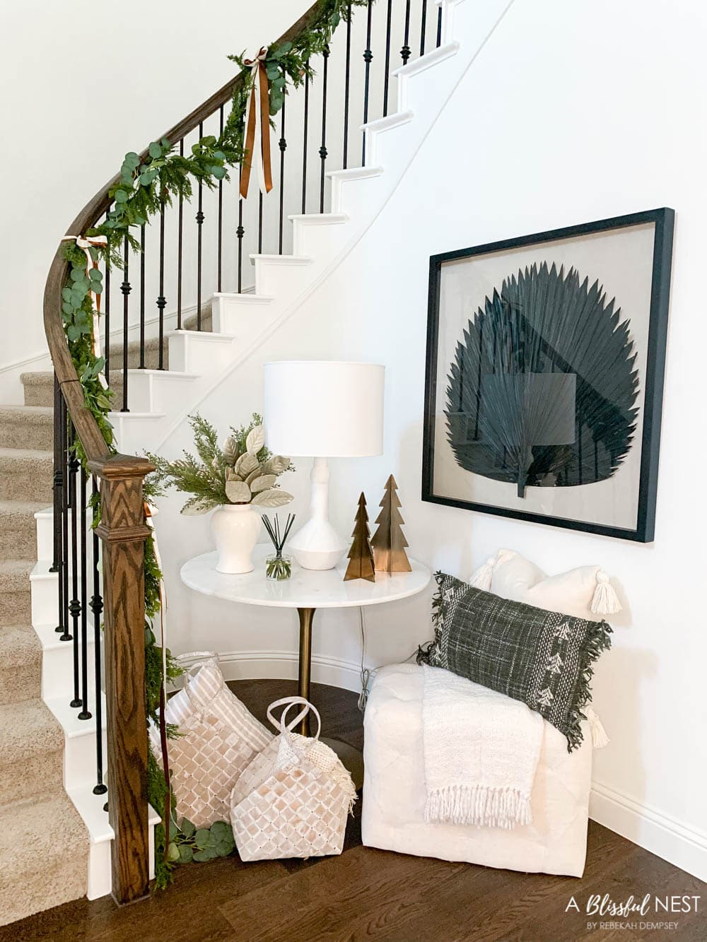 Christmas decor with pillows, baskets, metal trees, and garland on the stairway.