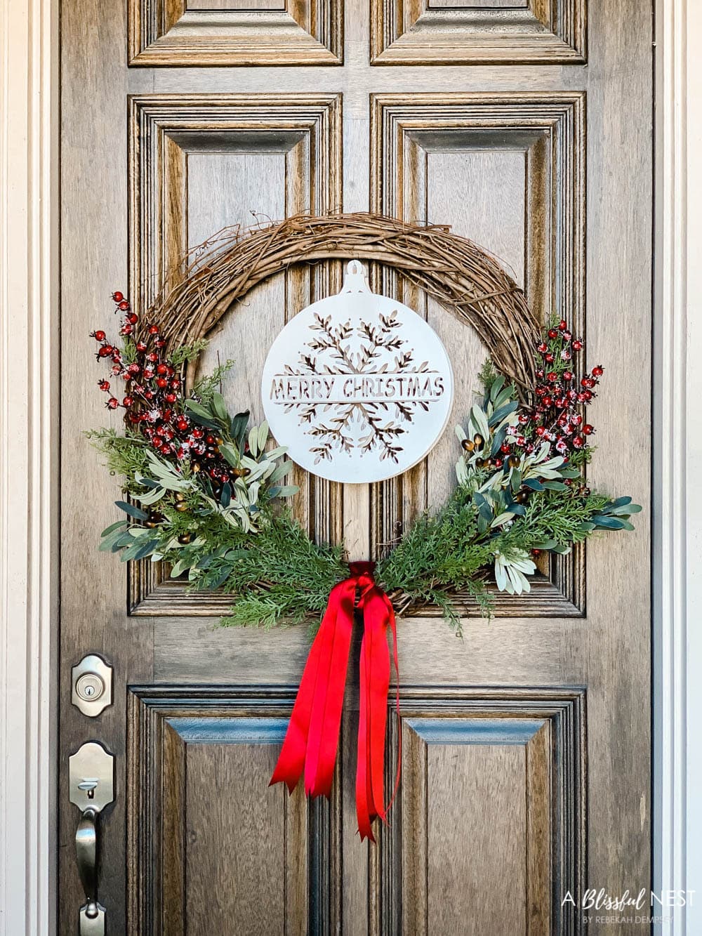 Step-by-step instructions to making this simple Christmas grapevine wreath for the holidays. #ABlissfulNest #HobbyLobby #sponsor #Christmaswreath