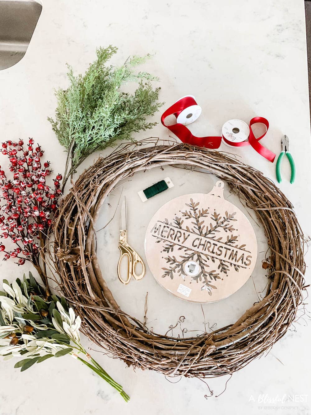 Step-by-step instructions to making this simple Christmas grapevine wreath for the holidays. #ABlissfulNest #HobbyLobby #sponsor #Christmaswreath