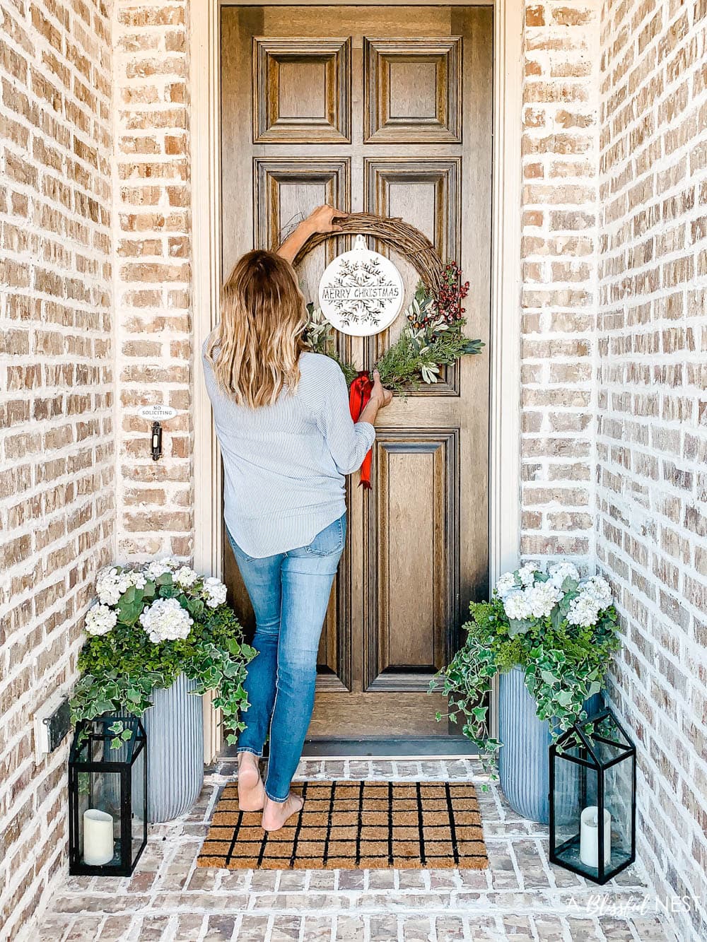 Step-by-step instructions to making this simple Christmas grapevine wreath for the holidays. #ABlissfulNest #HobbyLobby #sponsor #Christmaswreath