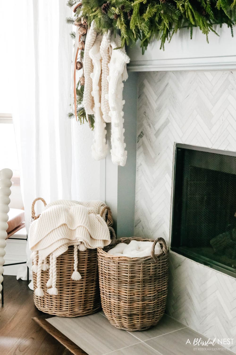 Baskets next to a fireplace filled with blankets