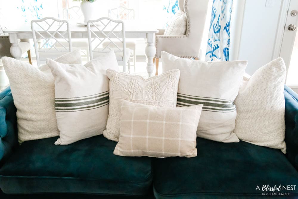 Cream and green pillows on navy sofa