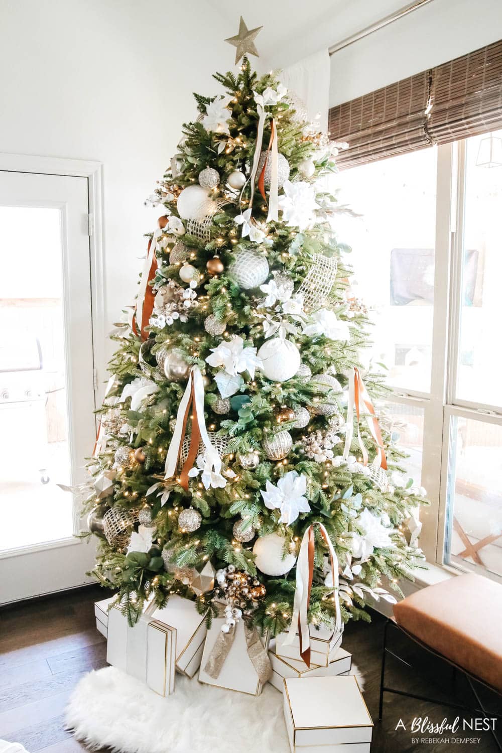 Christmas tree with gold, bronze and white ornaments.