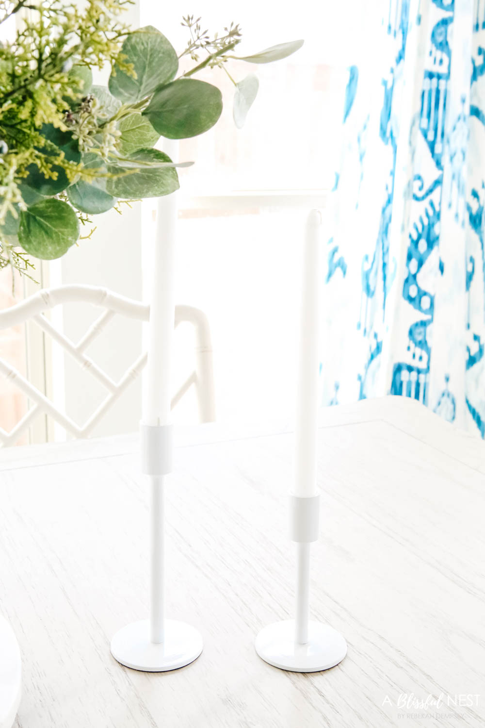 White modern candlesticks on a dining room table