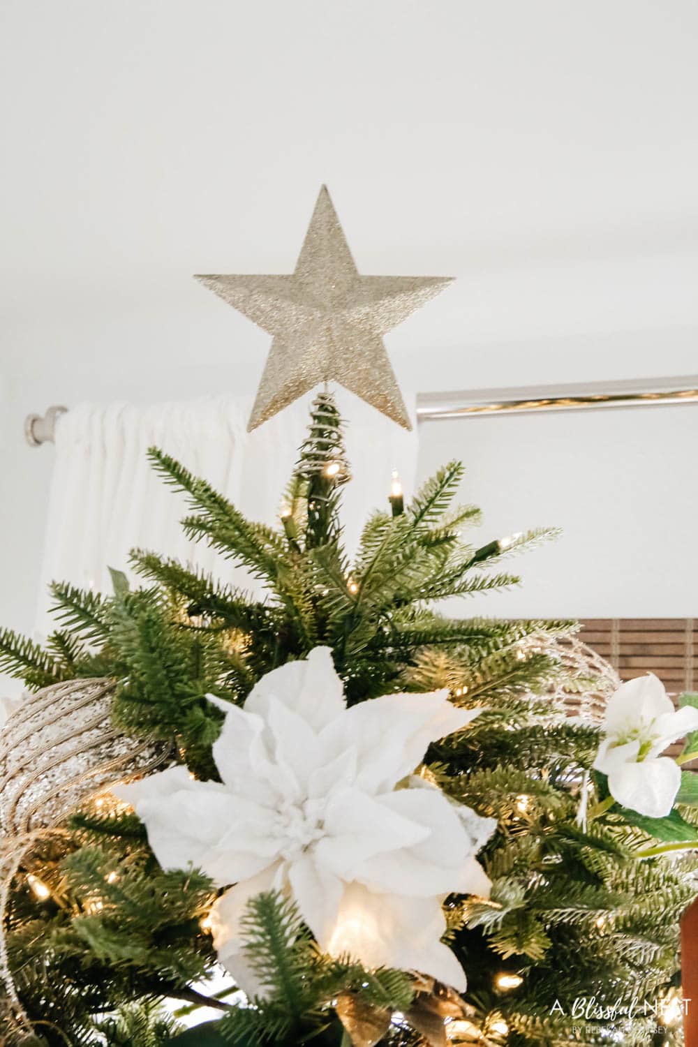Gold glitter star on top of a Christmas tree