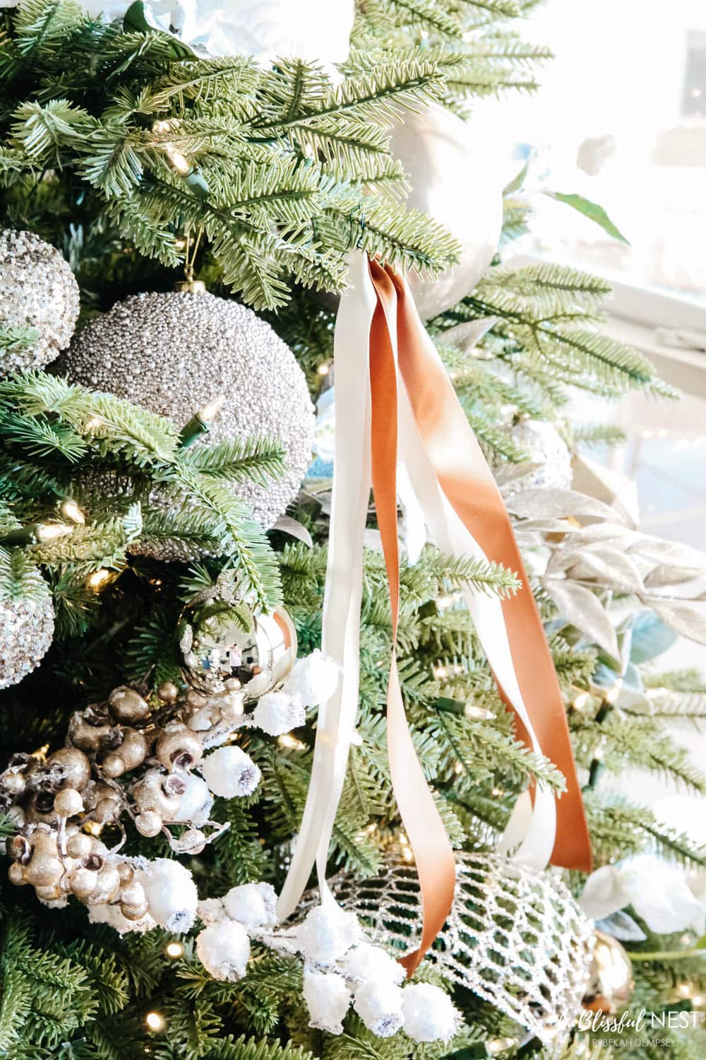 Bronze and white ribbons tied on a Christmas tree