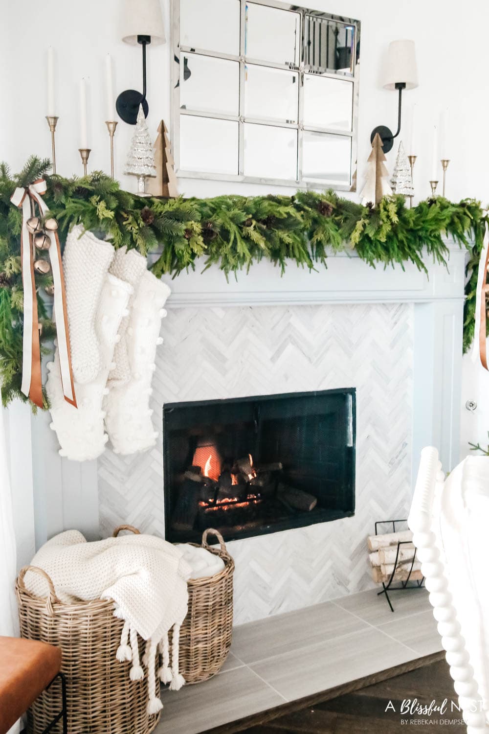 Christmas mantle with garland, bronze and white ribbons and chunky knit stockings