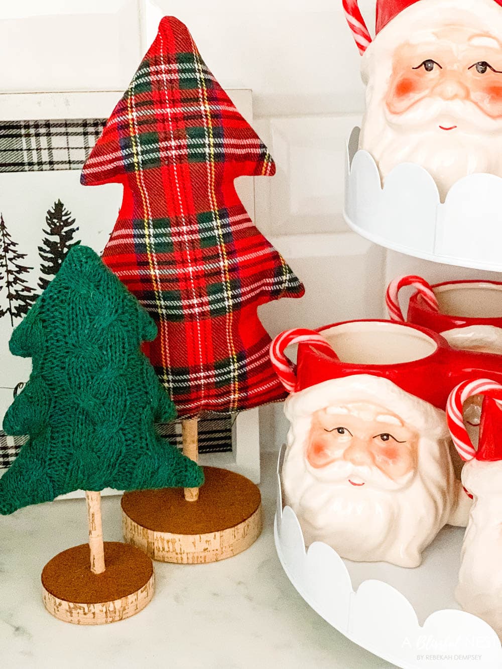 Plaid fabric Christmas tree and santa mugs on a tierd tray