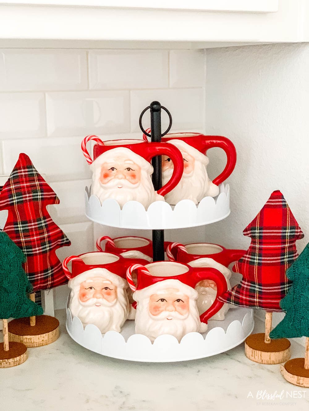 Santa mugs on a white tiered tray