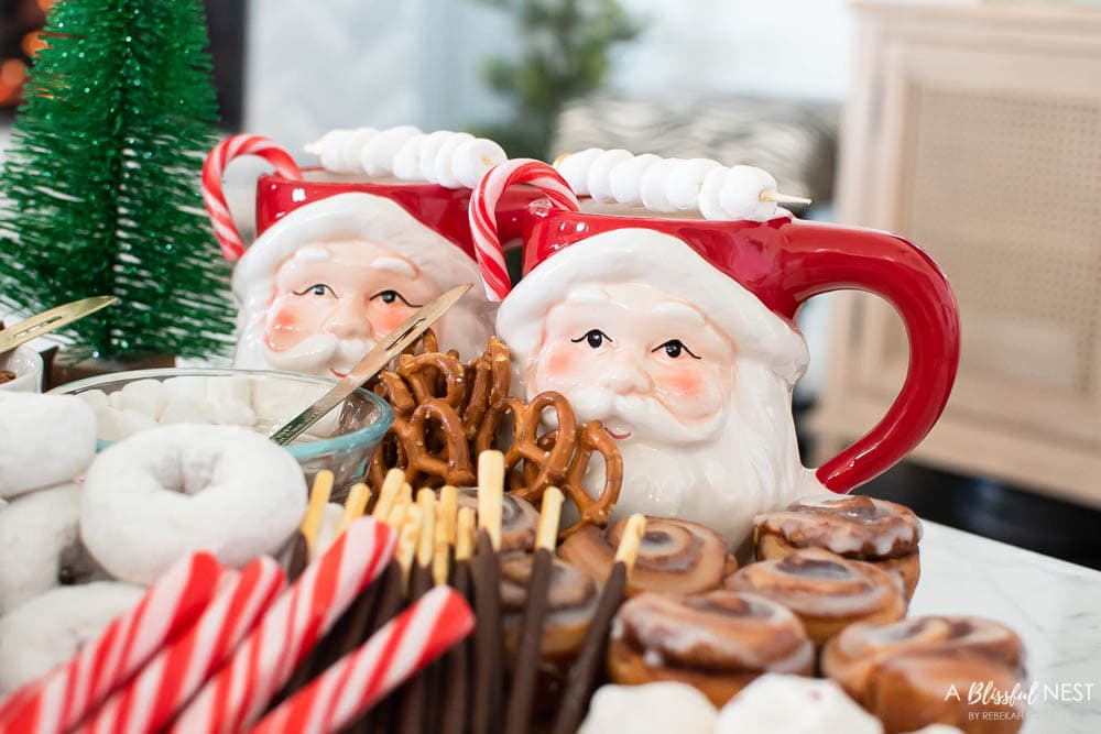 Santa mugs with candy canes in them