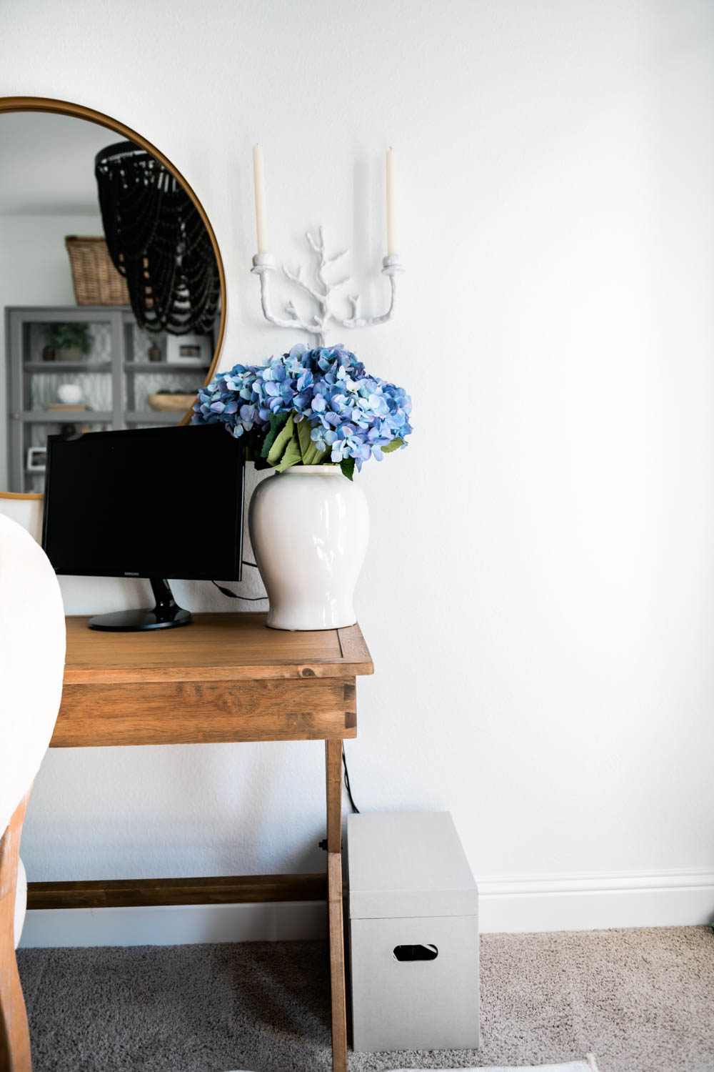 How white paint is such a contrast with a wood desk, black and grey accents in a small home office.