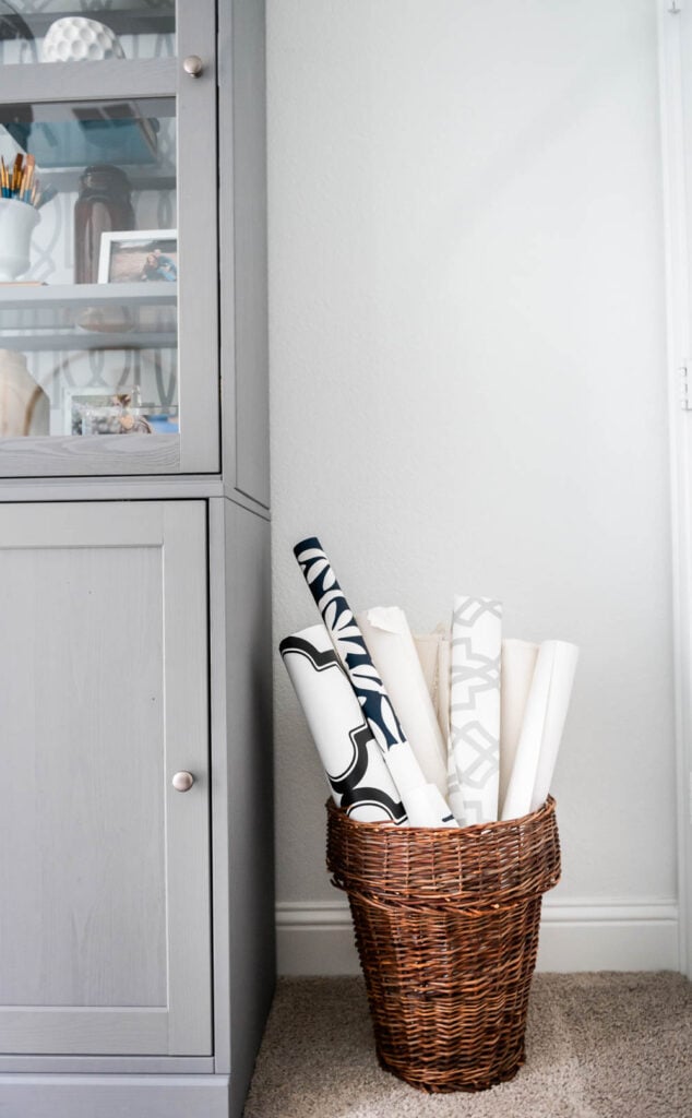 A basket filled with design plans rolled up and tucked in to store them/