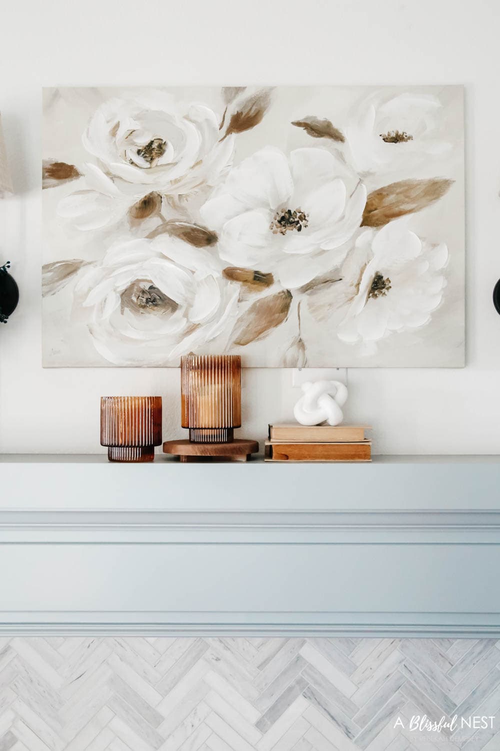 Beautiful magnolia on canvas artwork above a fireplace mantle.