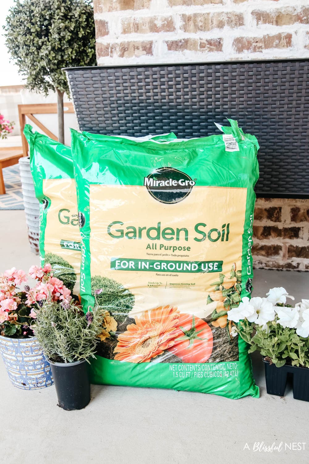 Bags of potting soil on a back porch to use to be planted