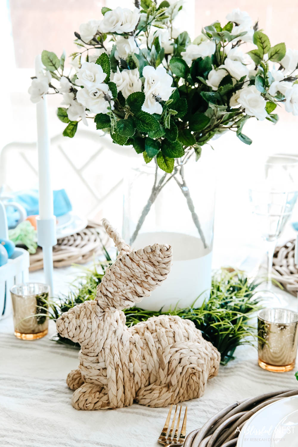Close up of basket weave bunny used in the center of the Easter table with white flowers in a vase