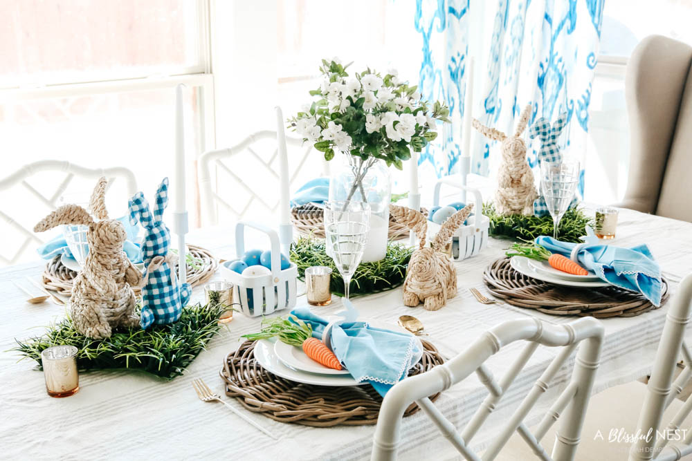 Easter table decor on a dining room table with a blue and white color scheme.