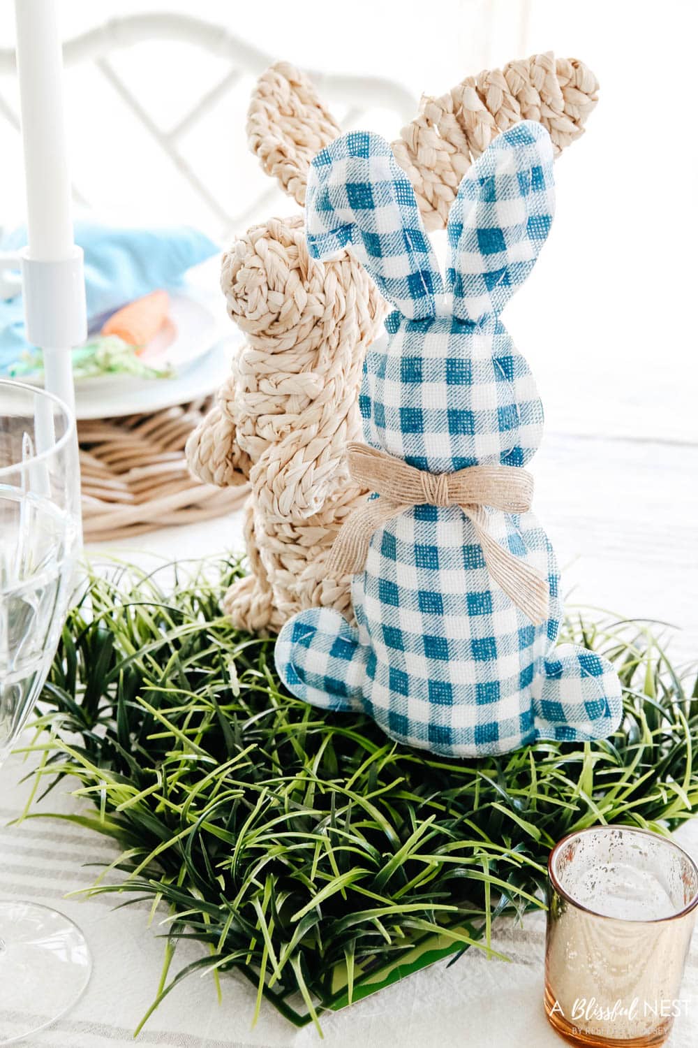 Blue and white gingham check bunny sitting on a grass mat
