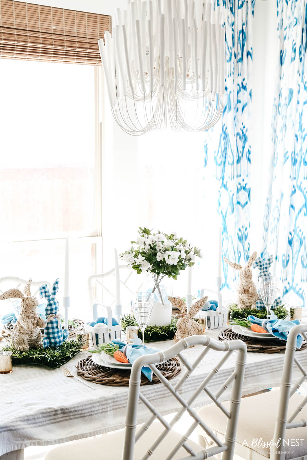 Easter table decor on a dining room table with a blue and white color scheme.