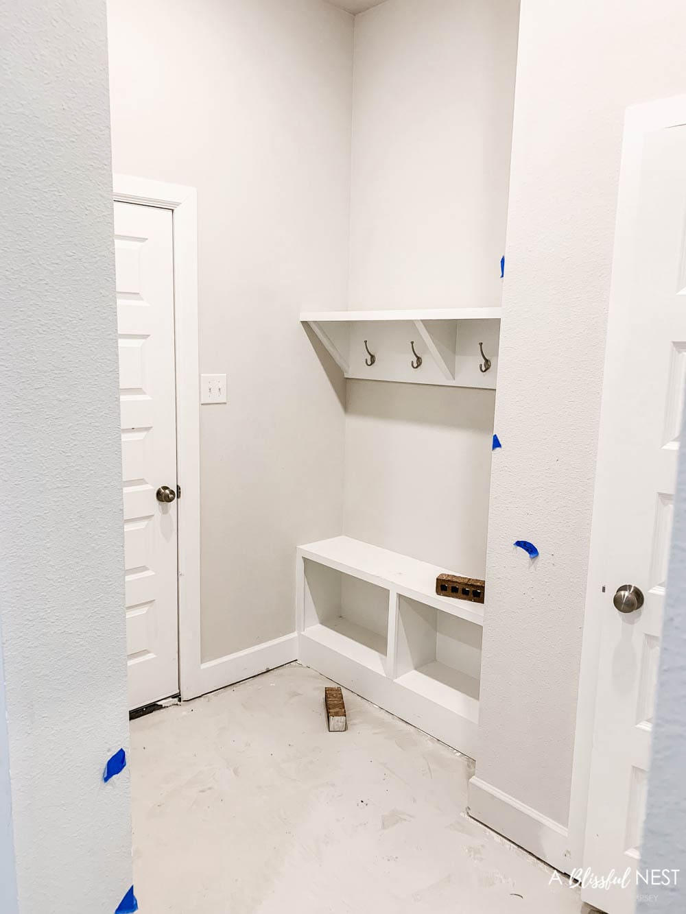 A view of a new construction mudroom right inside the garage door.