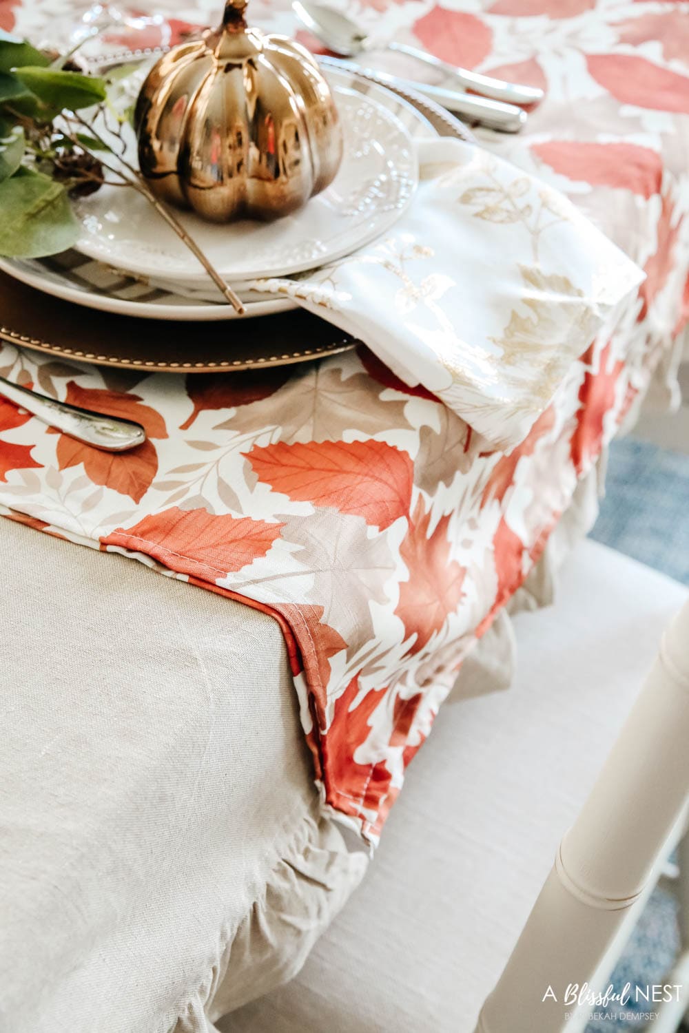 Layered linens in shades of orange and taupe