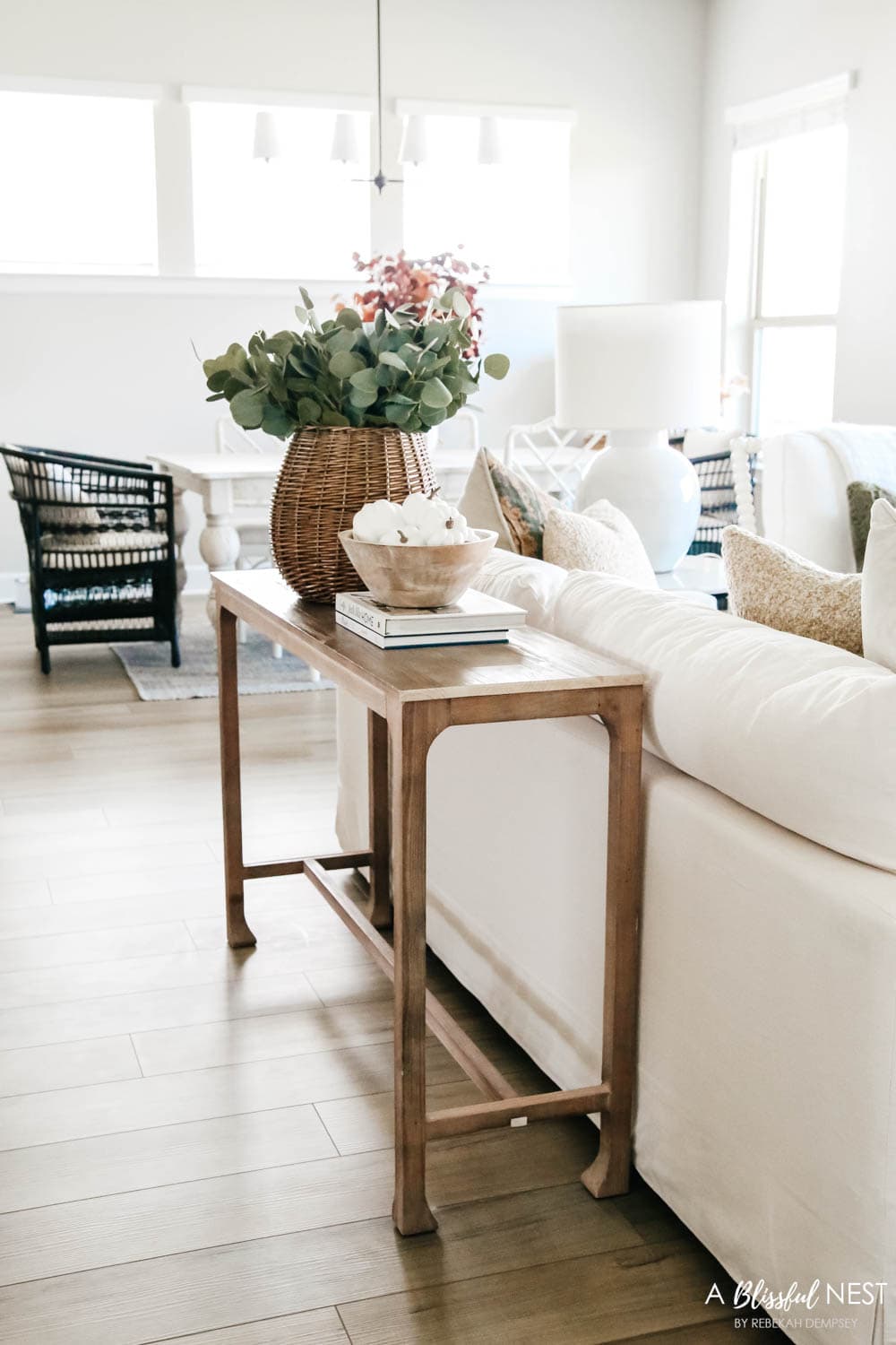 Sofa console table with basket of eucalyptus