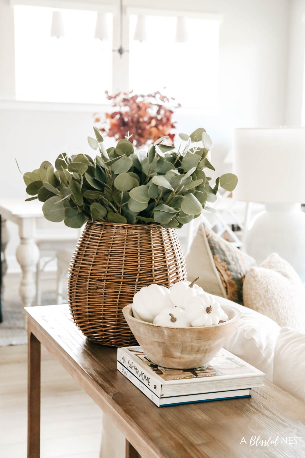 Sofa console table with basket of eucalyptus