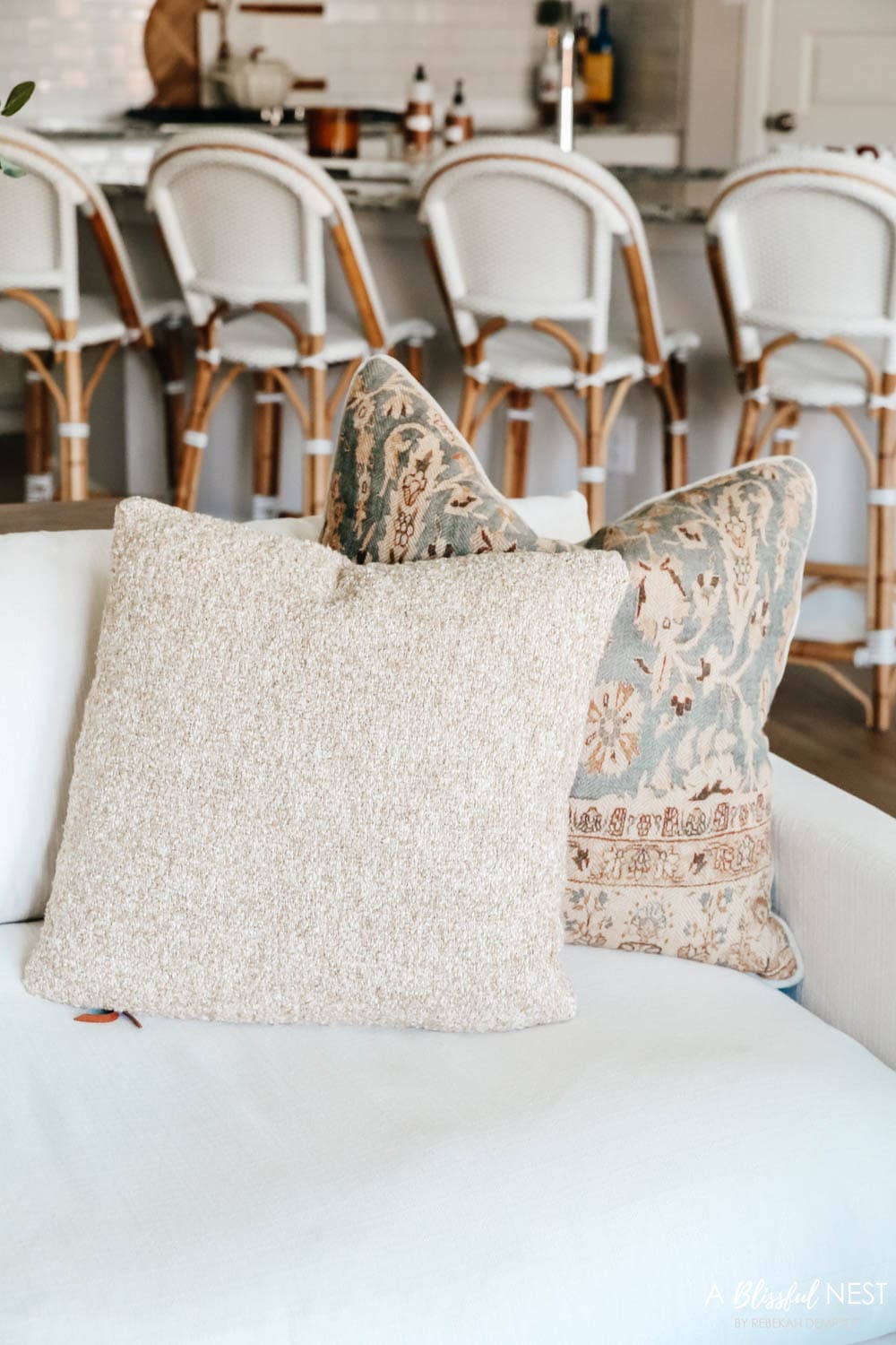 Fall hued pillows on a cream colored sofa