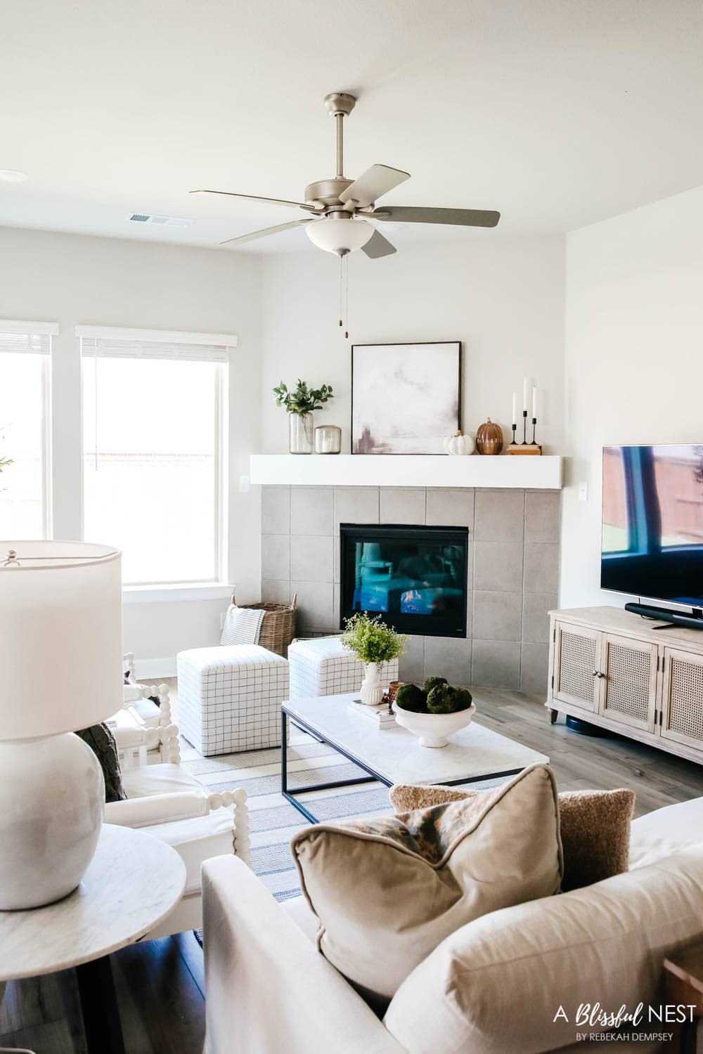 Living room view of a neutral home decor and fireplace mantle.