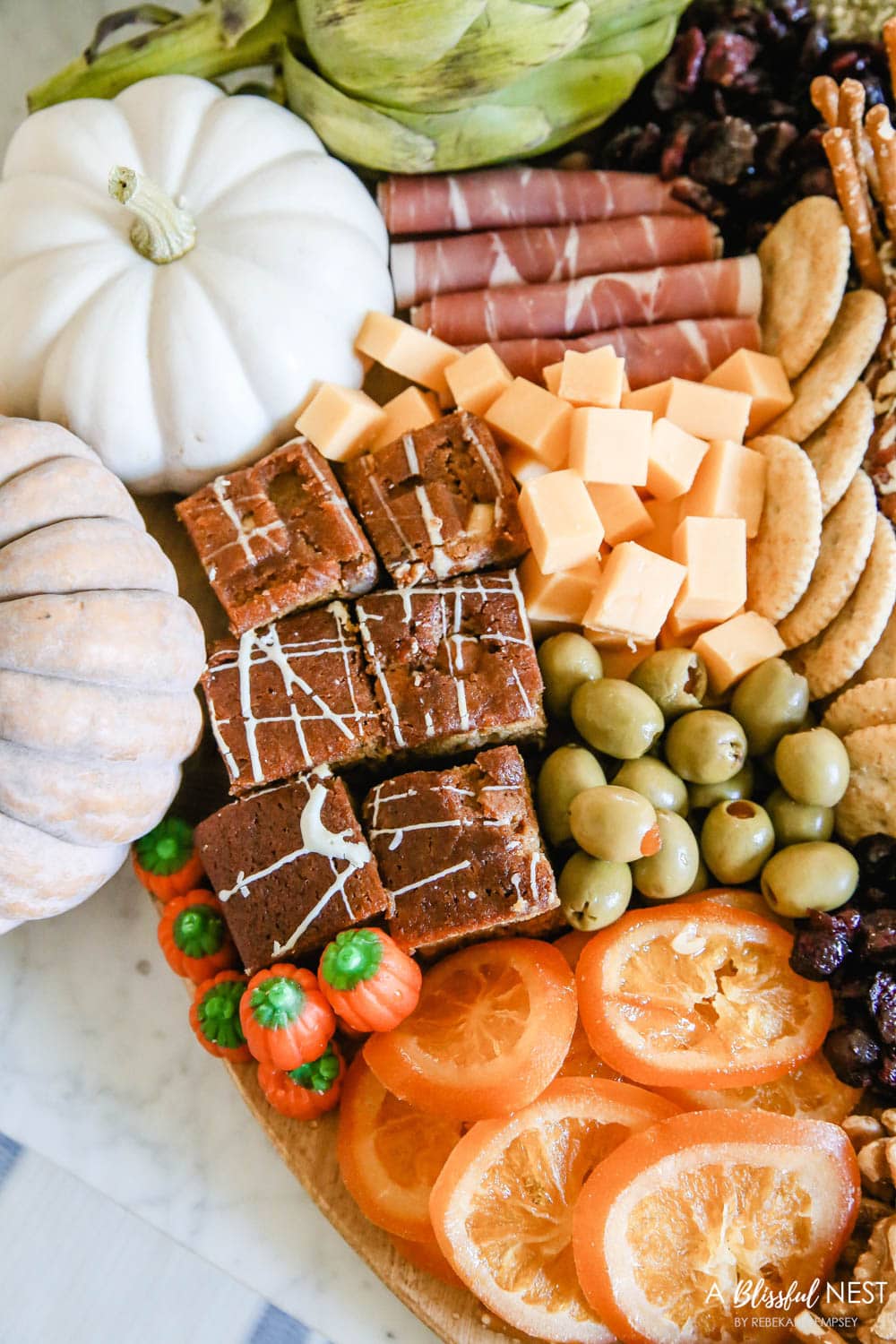 Sliced candied oranges, olives, cranberries, and cheese cut in cubes