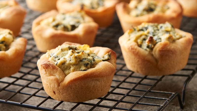 Mini pastries with spinach and artichoke in the middle