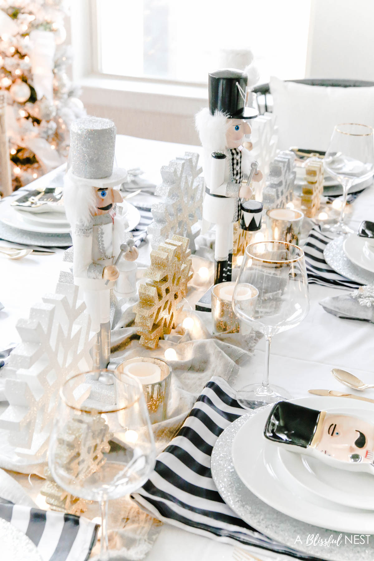 Set of three nutcrackers down the center of the table on top of a grey velvet runner