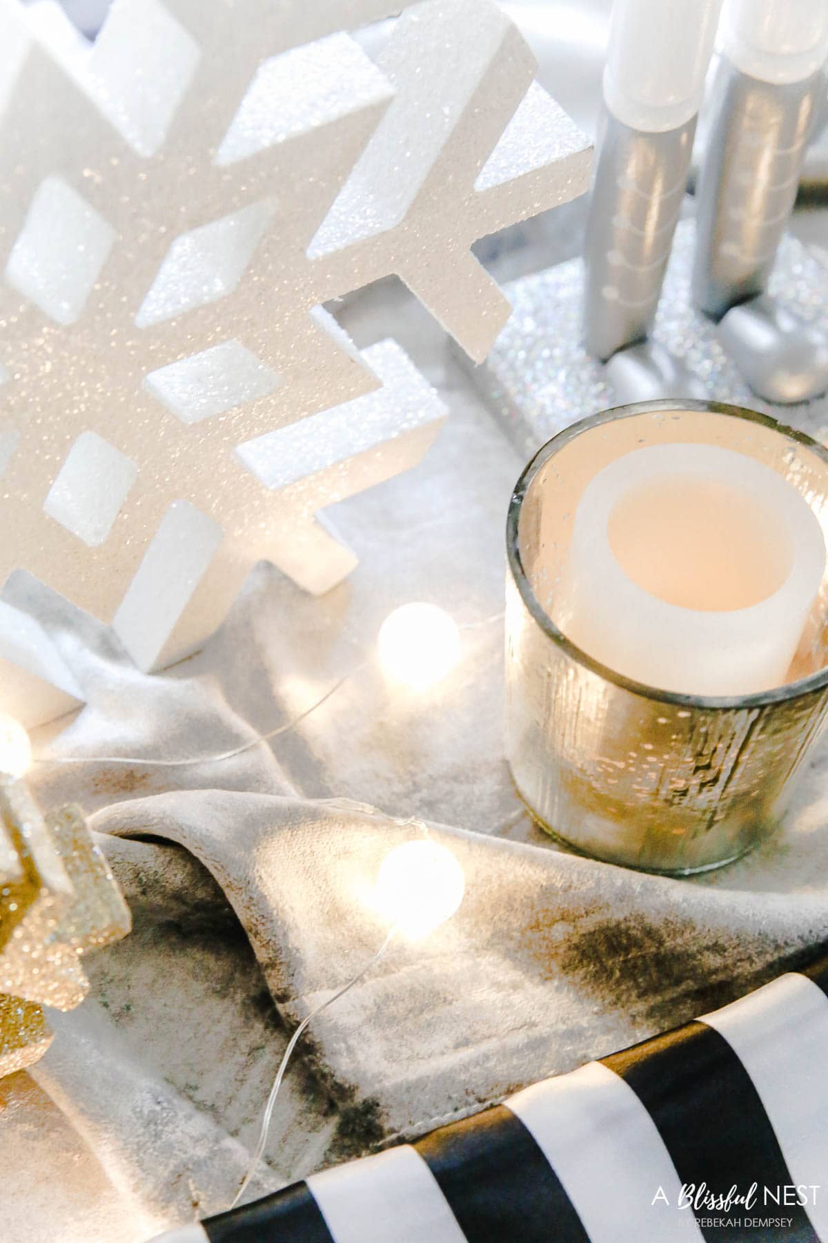 Small strand of frosted globe lights down the center of the holiday table