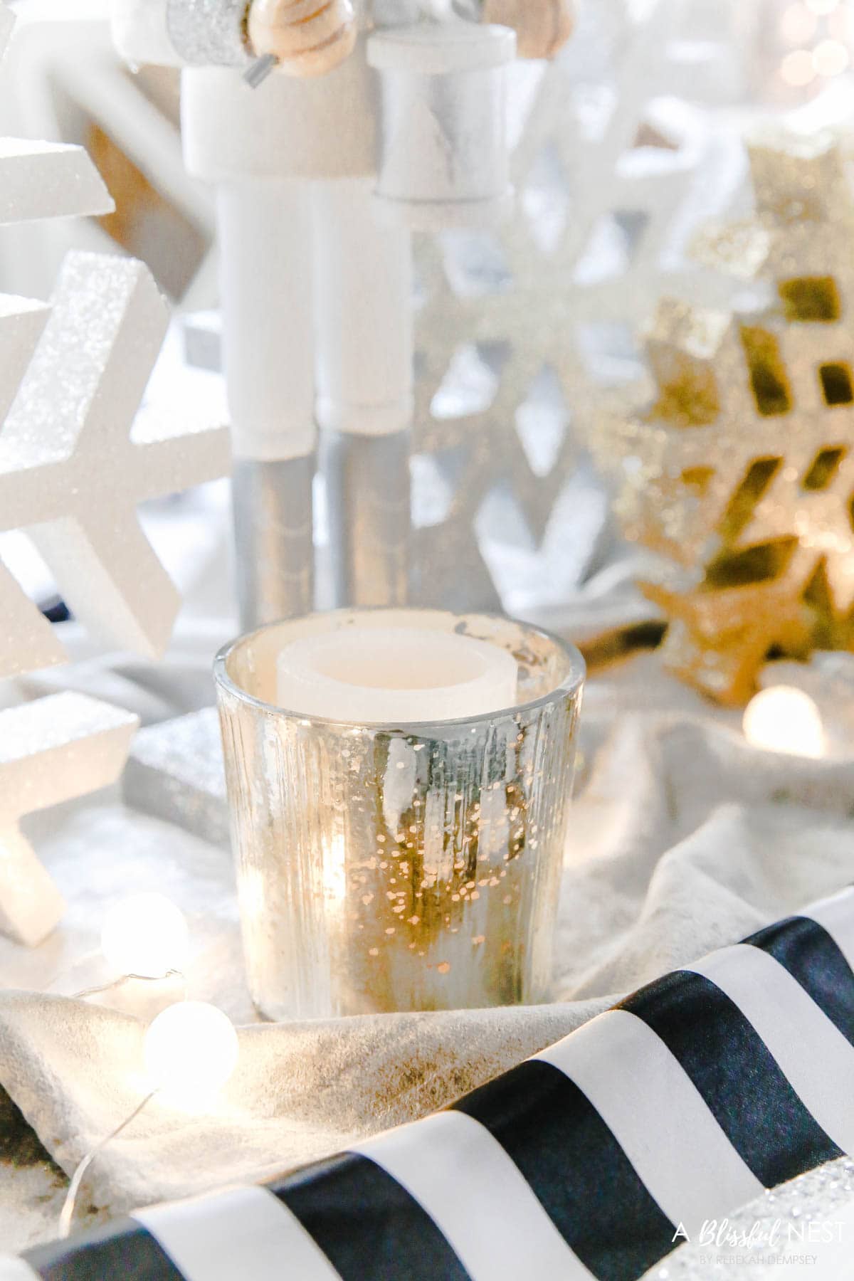 Small strand of frosted globe lights down the center of the holiday table