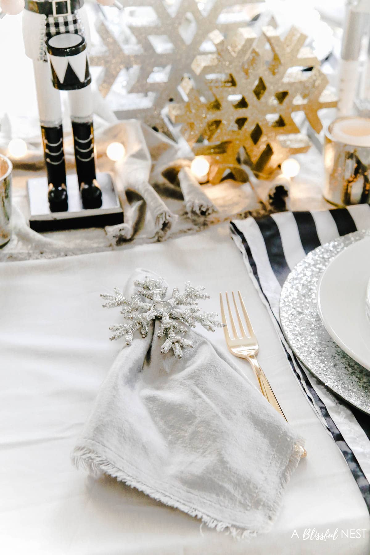 Silver velvet napkins next to gold flatware 