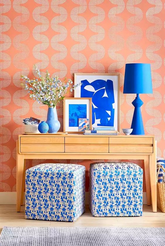 Canyon Ridge paint color shown in a wallpaper example with bright blue accessories on a side table