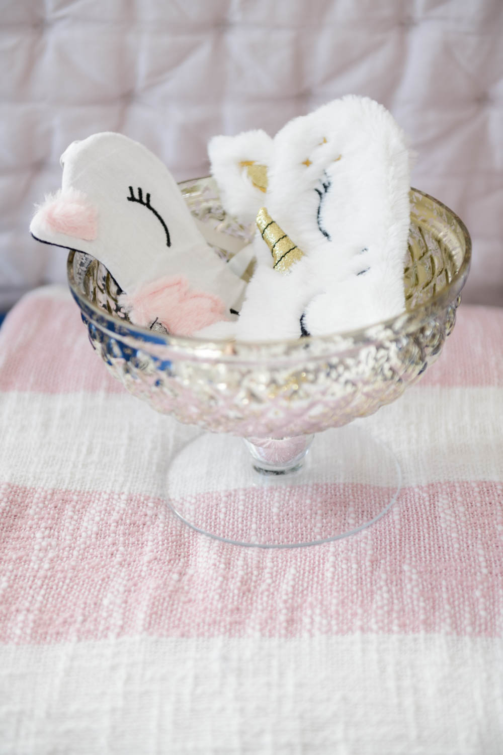 Childrens sleep masks in a mercury glass bowl