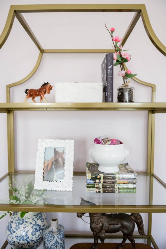 Gold bookcase filled with keepsakes