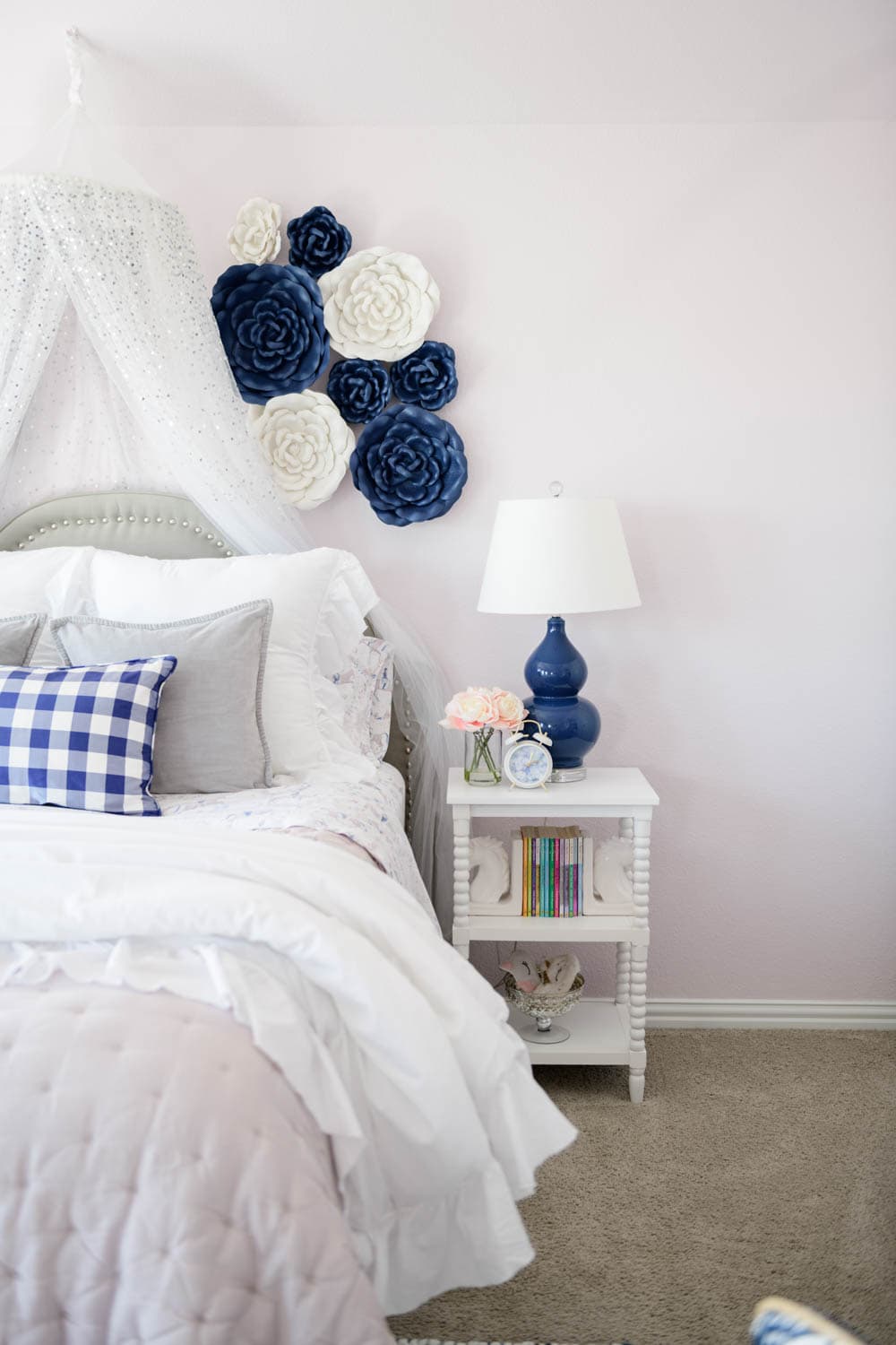 White spindle nightstand with navy blue table lamp