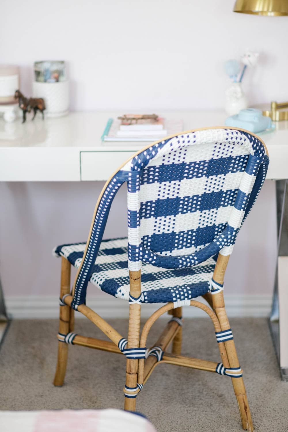 Blue and white checkered rattan chair in a tween bedroom for a desk chair
