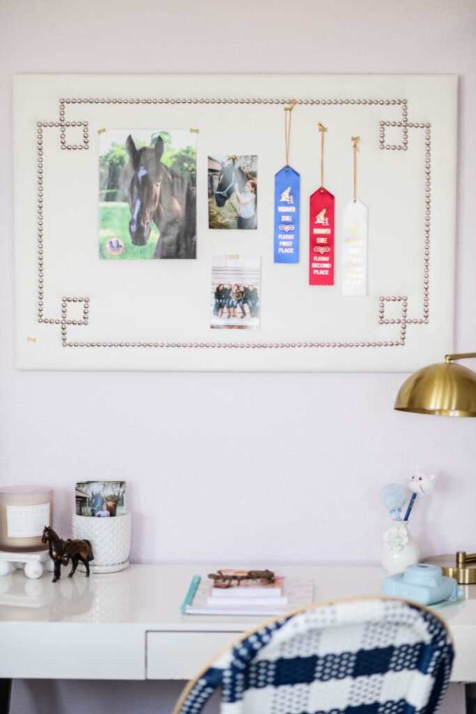 Bulletin board above a study desk in a tween bedroom.