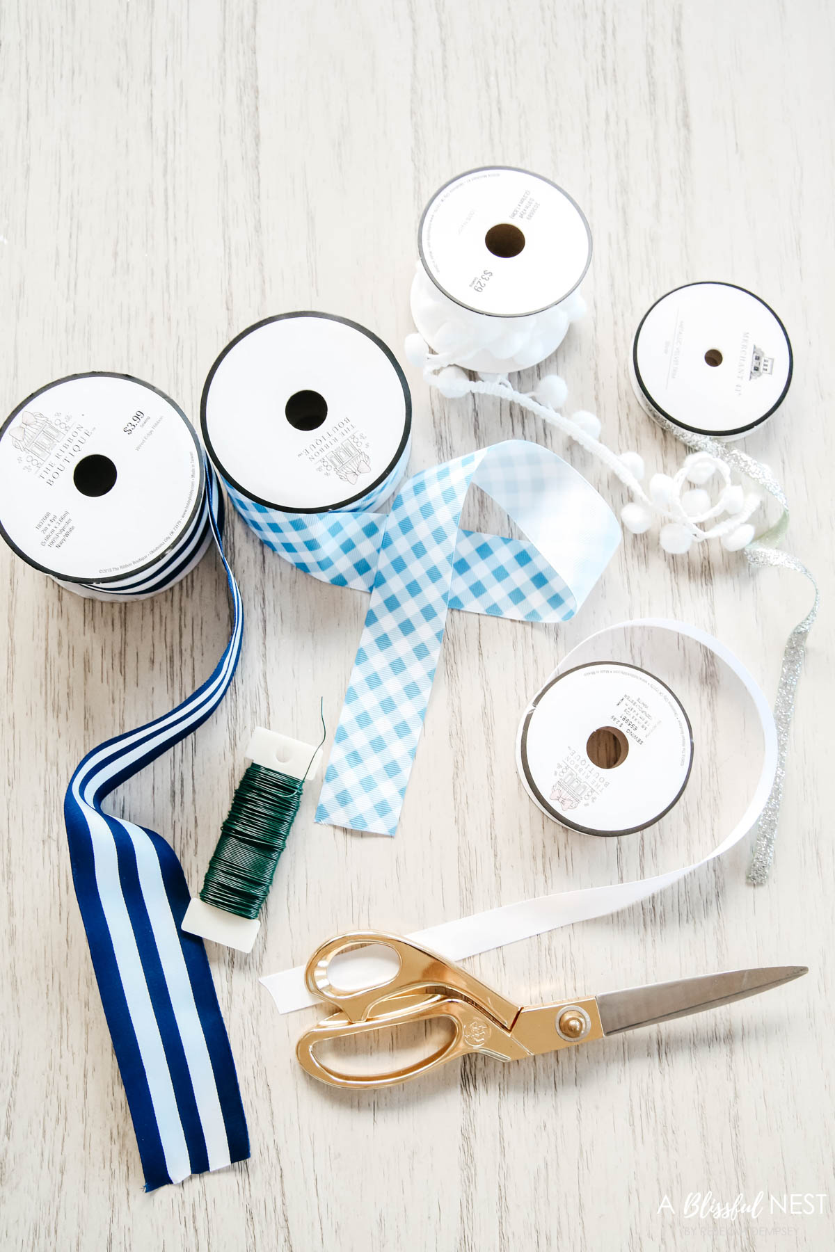 Collection of blue and white ribbons to create streamers for wreath.