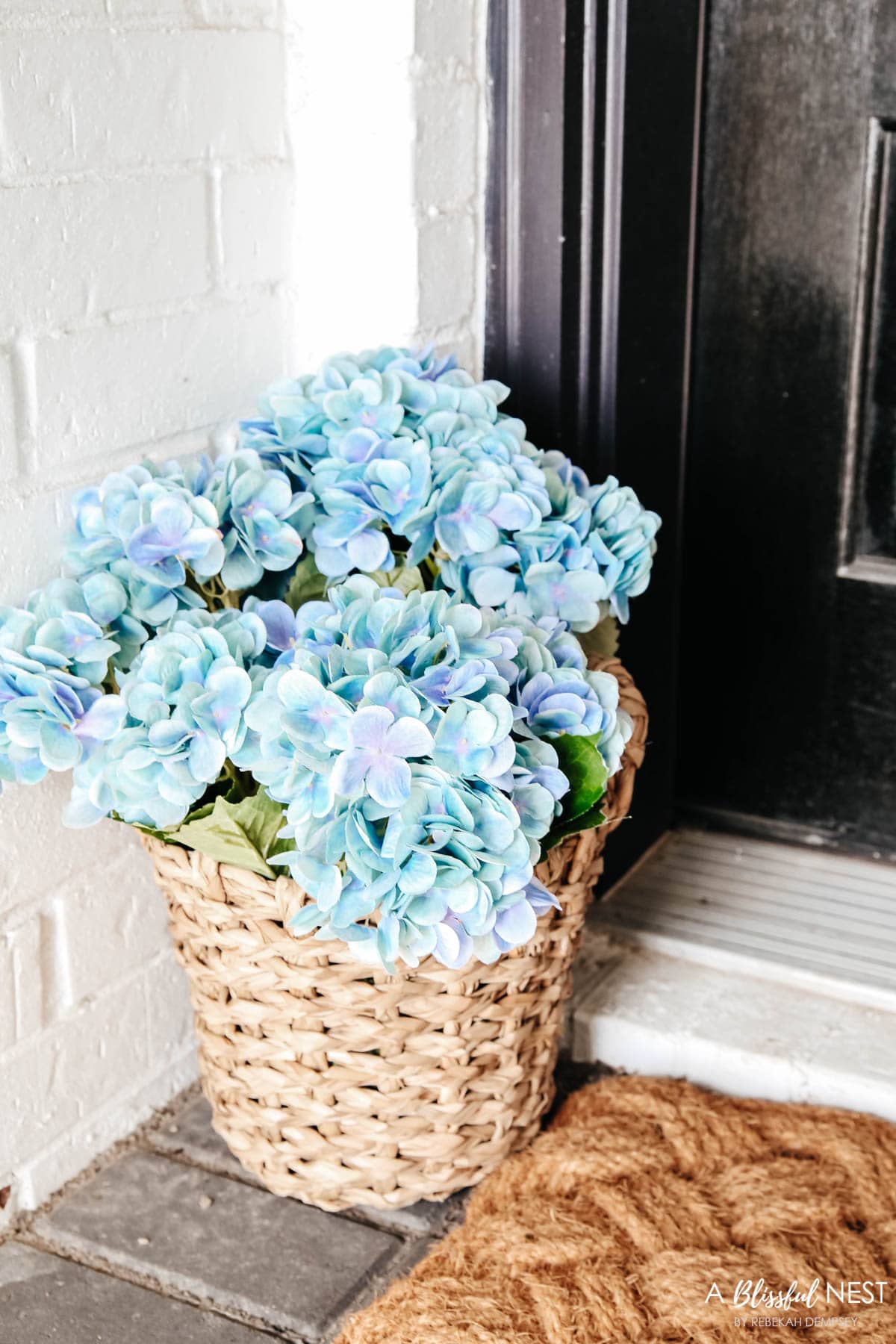 Detail view of small basket filled with light blue hydrangeas