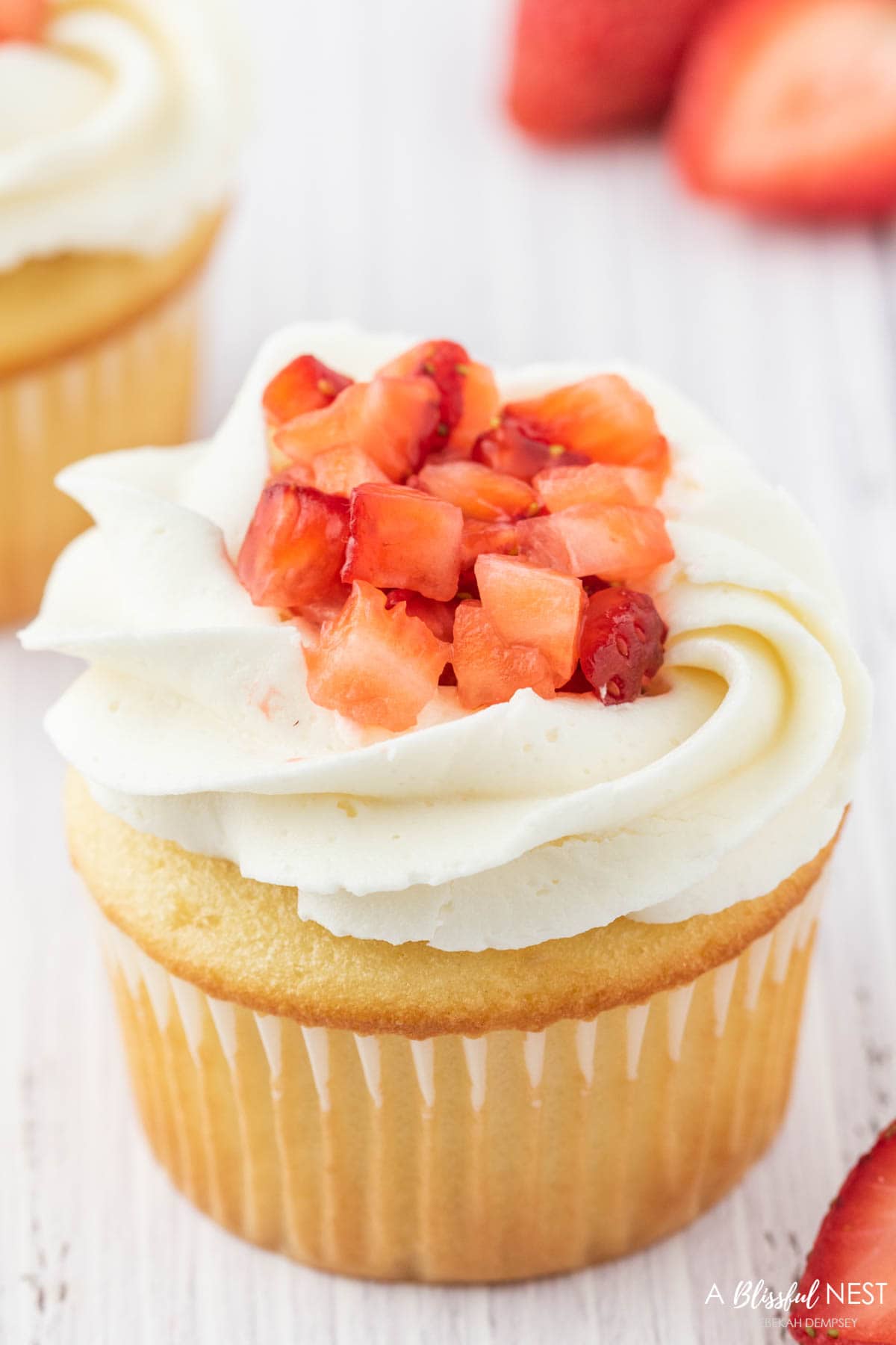 Strawberry cupcake with sliced strawberries on top