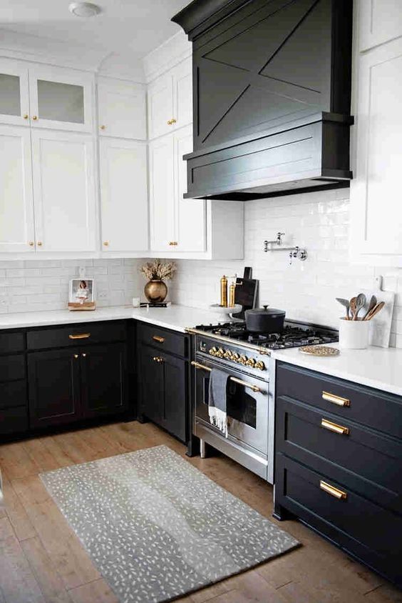 black and white kitchen cabinets with gold hardware.