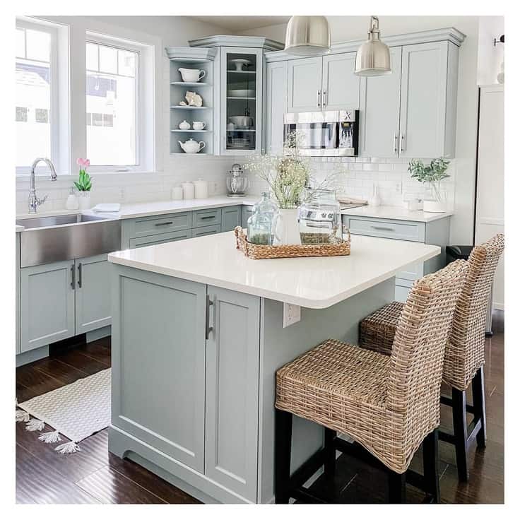 soft light blue gray paint color mixed with satin nickle hardware and white quartz countertops