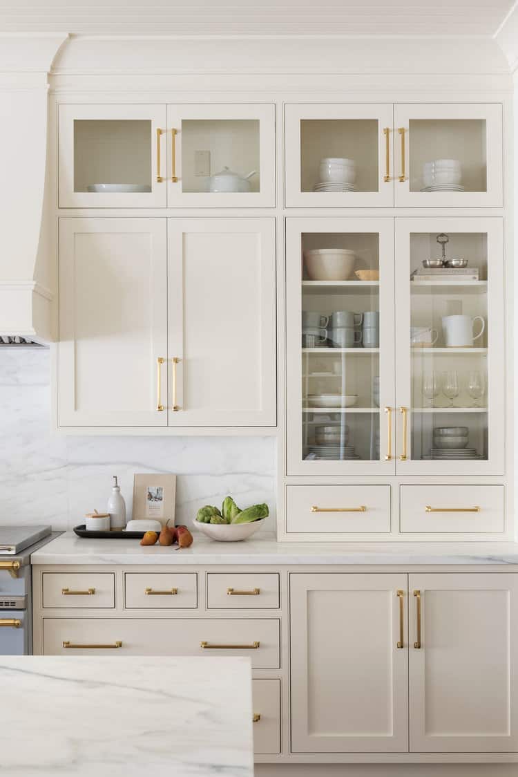 cream colored kitchen cabinets with gold hardware