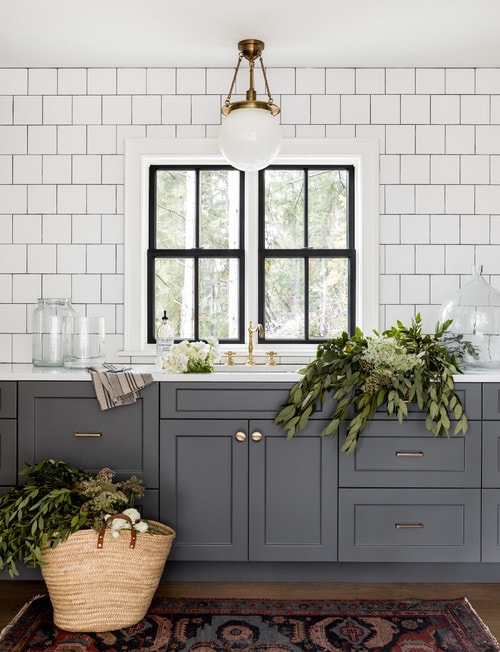 Dark gray kitchen cabinets, subway tile with dark gray grout. 