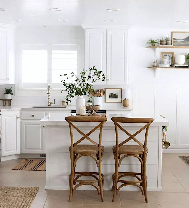 small white kitchen with farmhouse wood barstools and shiplap island. 